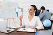 © VadimGuzhva - The travel agent keeps tickets for the plane in the travel agency.