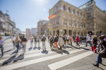 Crowd of anonymous people walking on busy city street