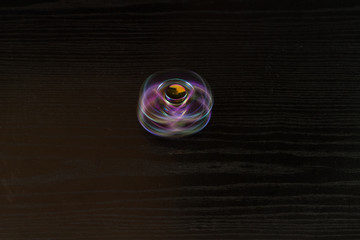  Colorful spinning swirl on a black table