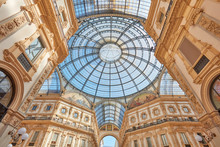 Milan, Vittorio Emanuele Gallery Interior, Wide Angle View In A Sunny Day. The Gallery Hosts Many Luxury Fashion Shop Of The Italian Fashion Capital.