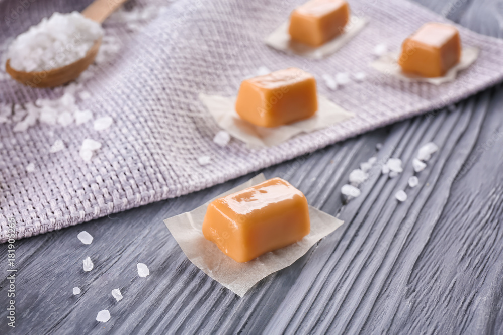 Salted caramel candies on wooden table