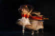 © zinkevych - Dance show. Attractive skillful young woman dancing and showing her performance while standing against black background