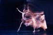 © zinkevych - Before performance. Nice skillful young woman standing against black background and dancing while training for her performance