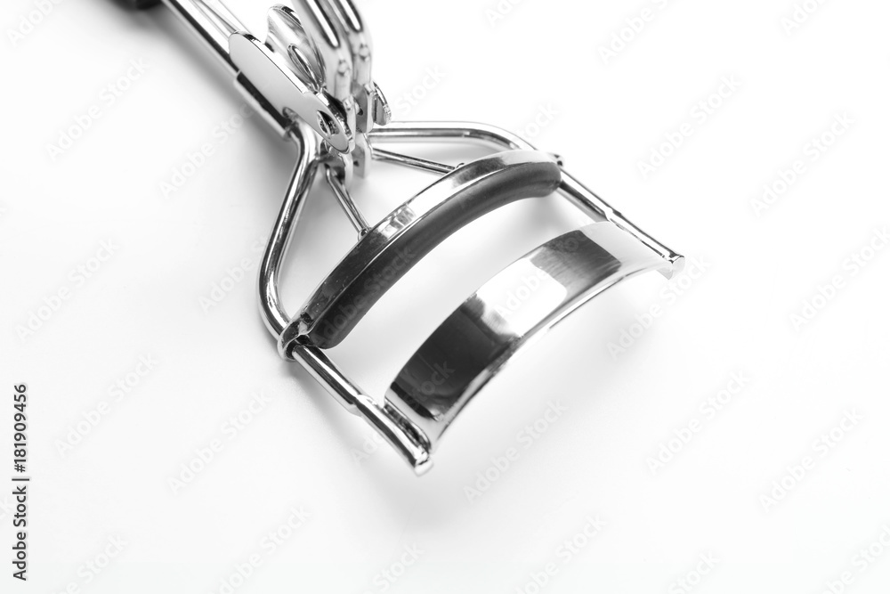 Eyelash curler on white background