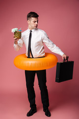 Sticker - Displeased young businessman looking at suitcase.