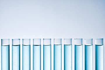 row of tubes with blue liquid frontal view