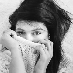 Wall Mural - Beauty portrait of young woman in white wool sweater. Monochrome