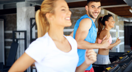 Group of friends exercising on treadmill machine