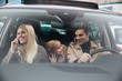 © Drobot Dean - Happy young man with family in car