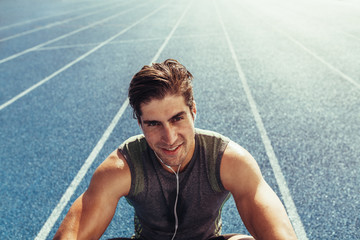 Wall Mural - sprinter relaxing on running track