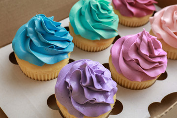 Poster - Tasty colorful cupcakes in cardboard box, closeup