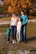 © Gorodetskaya - A happy family having fun in the park in autumn walking and hugging. Family, love, happiness concept. Family of four with mother father sister and a little cute brother