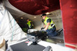 © Tyler Olson - Workers Loading Luggage In Airplane