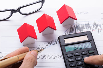 Hand Calculating Financial Chart With Calculator