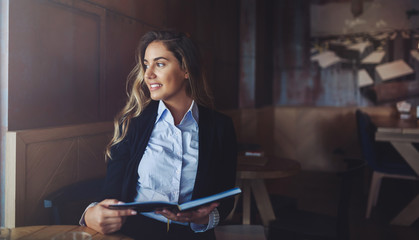 Beautiful woman reading notebook