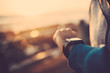 © Criene Images - Close up of man using his smart watch outdoors