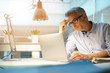 © goodluz - Businessman working in office with laptop computer