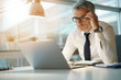 © goodluz - Businessman working on laptop in office, being concerned