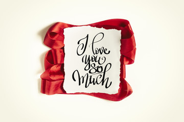 Wall Mural - Inscription I love you so much. Red ribbon on white background. Flat lay