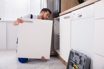 Handyman Fixing Sink Door