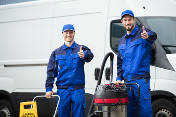 Wall Mural - Portrait Of Two Happy Male Janitors