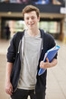 © Monkey Business - Portrait Of Male Student Standing In College Building