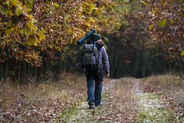 professional photographer with camouflage outfit in nature