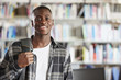 © Monkey Business - Portrait Of Male Student Standing In College Library