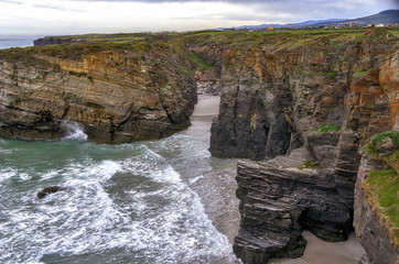 Wall Mural - Cathedrals beach rock formations and cliffs with high tide, in Ribadeo, Galicia, Spain.