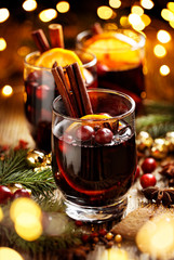 Wall Mural - Mulled wine, Christmas hot drink with addition aromatic spices, citrus fruit and cranberries on a wooden rustic table