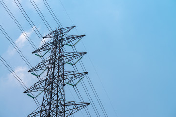 High voltage electrical tower with blue sky.