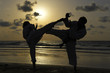 Karate fighters at sunset on the beach