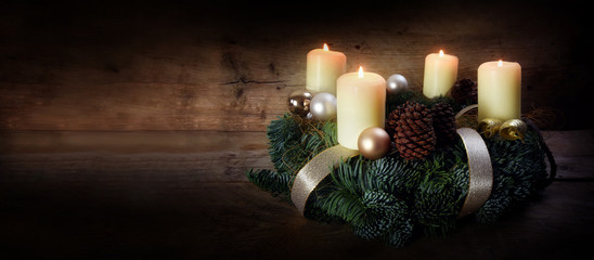 Wall Mural - Advent wreath with four white burning candles and christmas decoration on rustic dark wood, panorama format with copy space