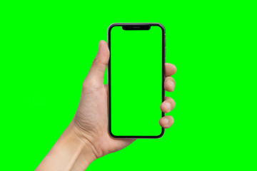 man's hand shows mobile smartphone with green screen in vertical position isolated on green backgrou