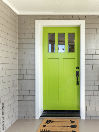 Fotografie, Obraz A front entrance of a home with a green entry door, front door & door mat