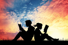 Couple Reading A Book At Sunset