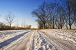 © beachfront - Snowy winter road against sunset sky