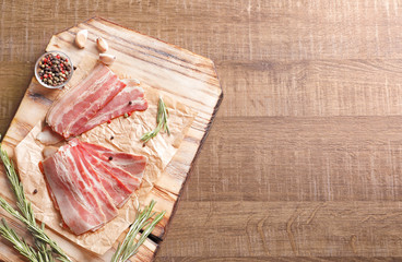 Wall Mural - Rashers of bacon on wooden board