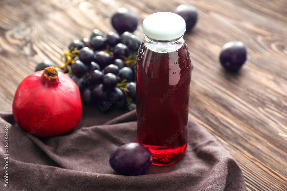 Bottle of freshly squeezed fruit juice on table