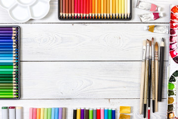 Artist workspace on white wooden background.