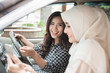 © Odua Images - two young asian woman in the car