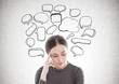 © ImageFlow - Stressed young woman in brown, speech bubbles