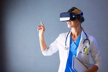 Female doctor wearing virtual reality glasses isolated on white background