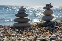 Stones And Pebbles Stack, Harmony And Balance, Two Stone Cairns On Seacoast