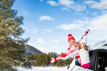 Happy family travel by car in winter