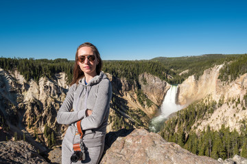 Wall Mural - Tourist overlooking waterfall in Yellowstone