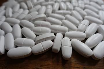 White tablets on the table (dietary supplement of calcium)