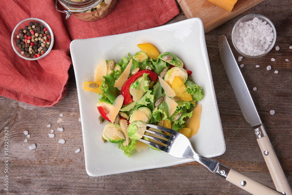 Plate of tasty salad with Brussels sprouts on table
