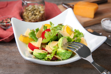 Wall Mural - Plate of tasty salad with Brussels sprouts on table