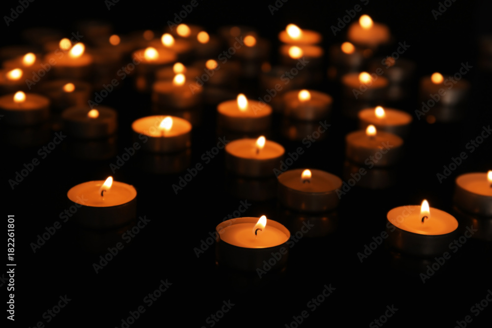 Burning candles on dark background